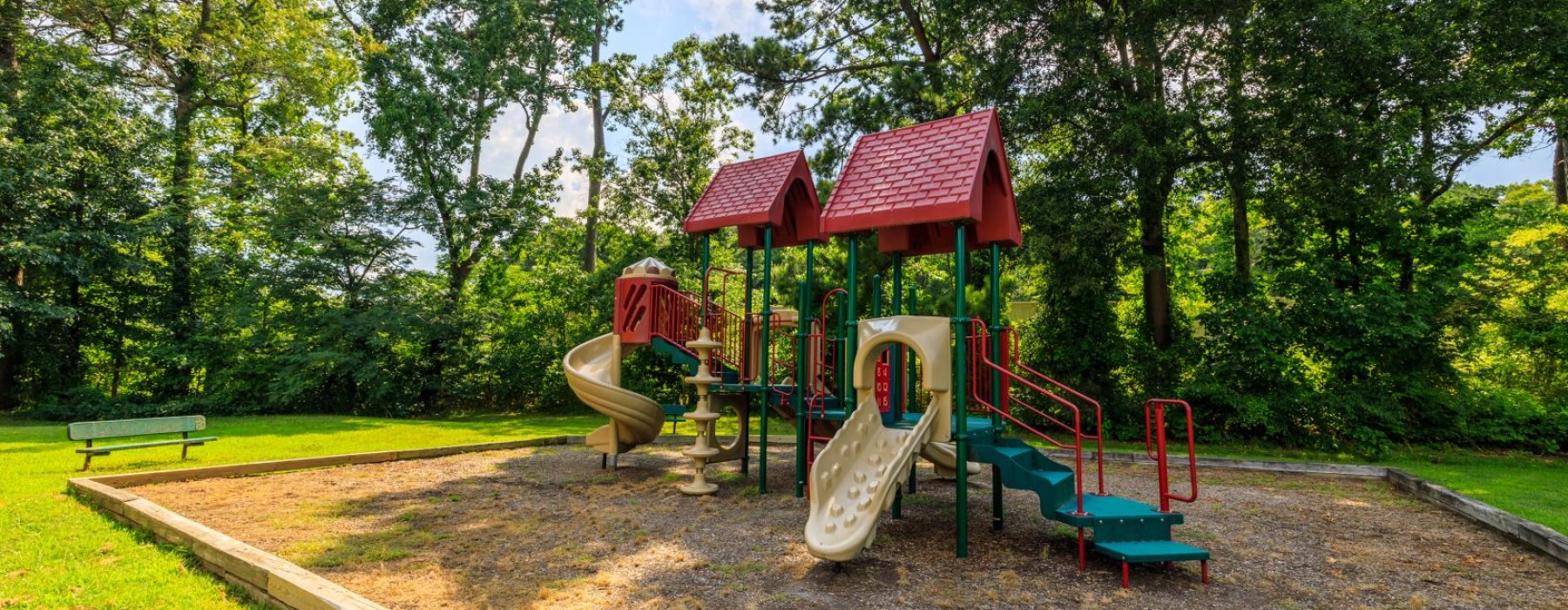 a playground with trees and grass