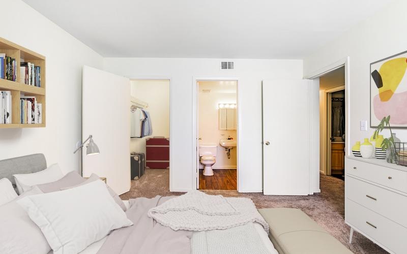 a bedroom with white furniture